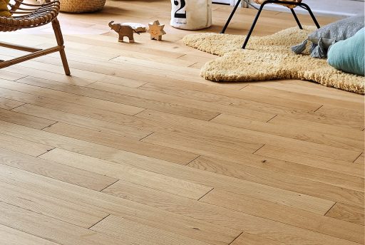 Clean light hardwood floor in a living room with a natural well maintained finish