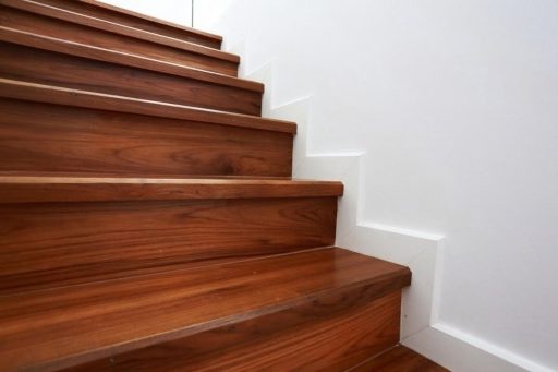 Refinished wood stairs with a smooth natural finish and restored color