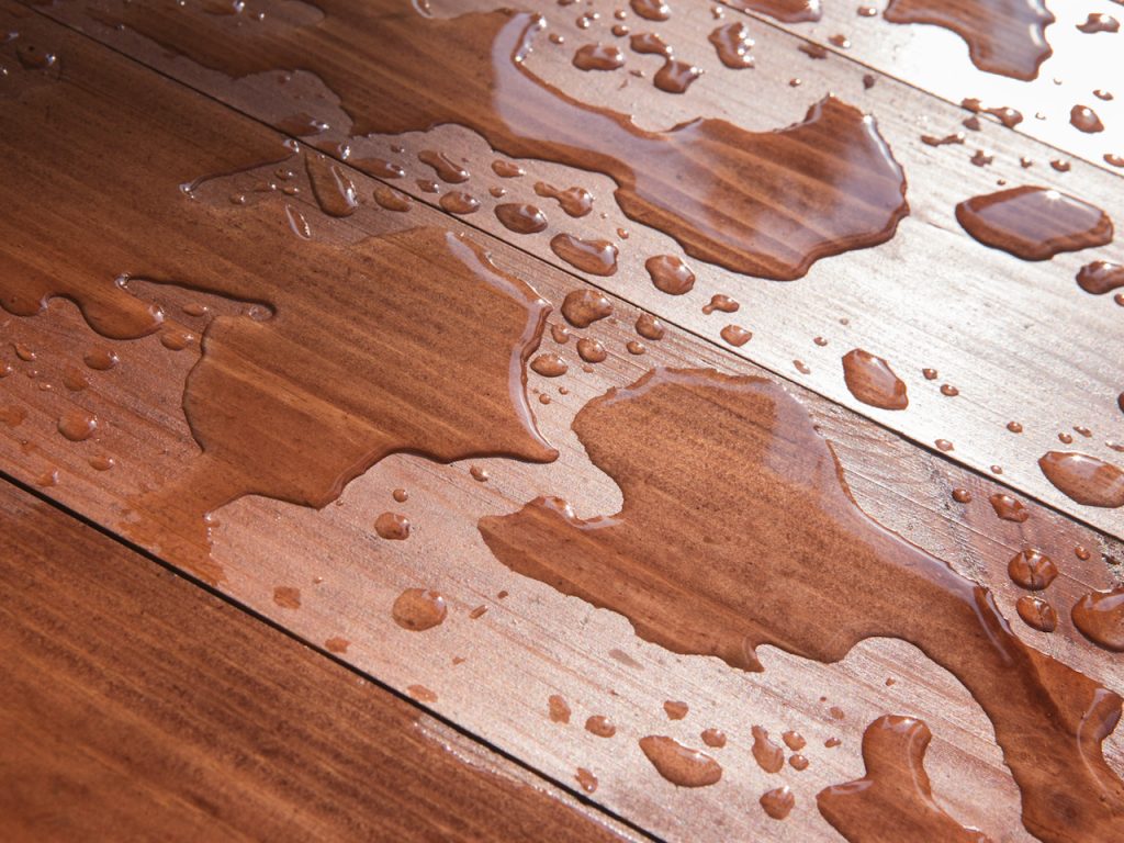 Water on hardwood floor before staining and finish damage turn into deeper discoloration or marks