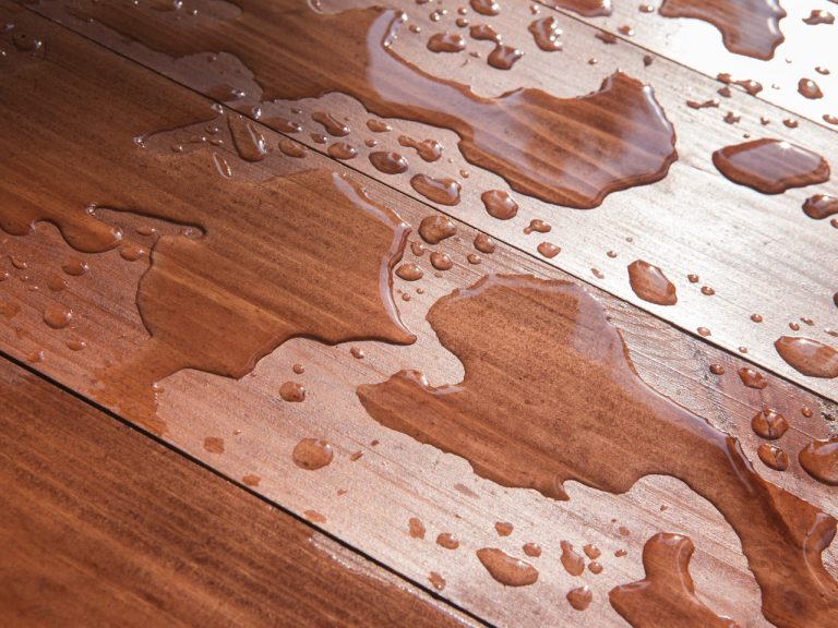 Water on hardwood floor before staining and finish damage turn into deeper discoloration or marks