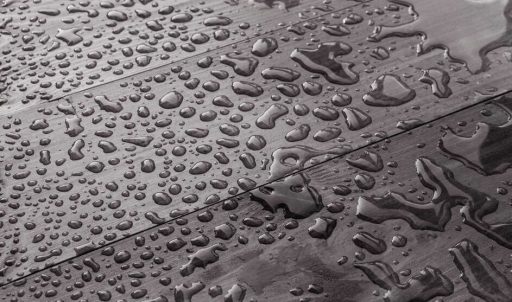 Water spots on hardwood floor surface showing the kind of moisture exposure that can lead to staining and finish damage