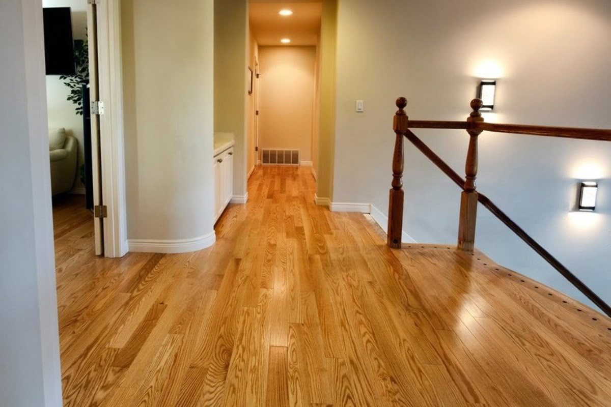 Hallway hardwood floor with stairs and light showing a typical home setting where indoor conditions matter for floor projects